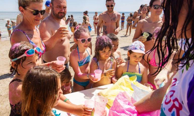 Children and adults enjoy a festive day at the beach.