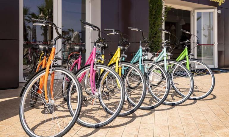 Colorful bicycles parked in front of a building.