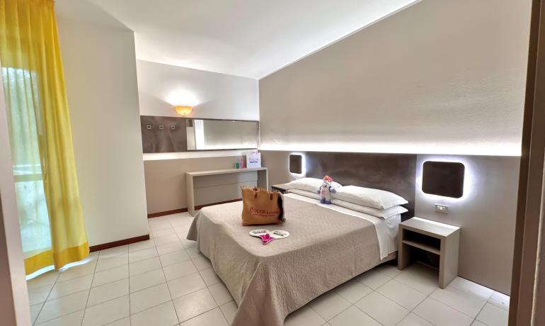 Chambre moderne avec lit double et décoration minimaliste.