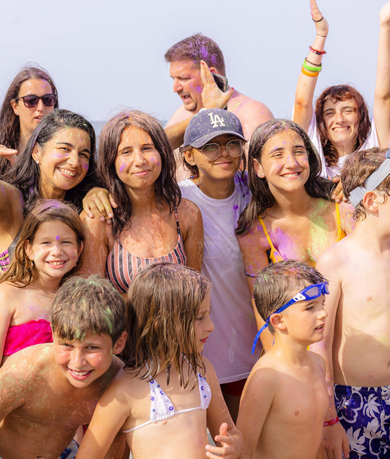 Joyful group, colorful and smiling, celebrating under the sun.
